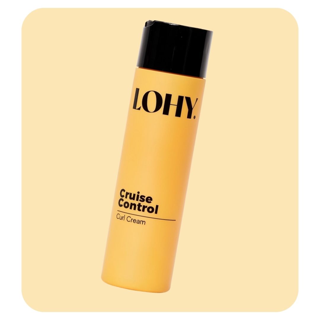 lohy cruise control curl cream 250ml bottle angled on a pastel yellow background