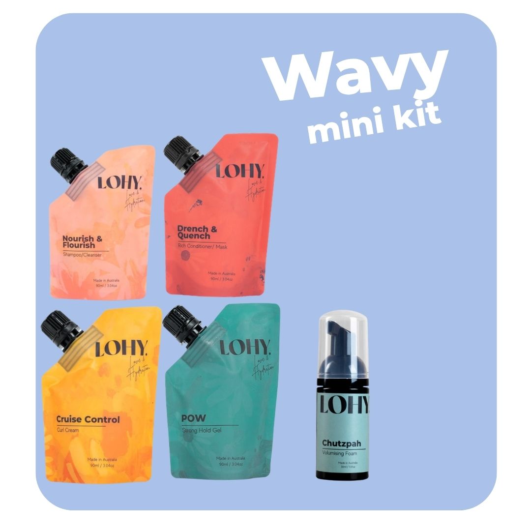 lohy. curly hair mini kit, which includes mini shampoo, mini rich conditioner, mini curl cream, mini strong hold gel pouches, and a mini chutzpah bottle on a pastel blue background