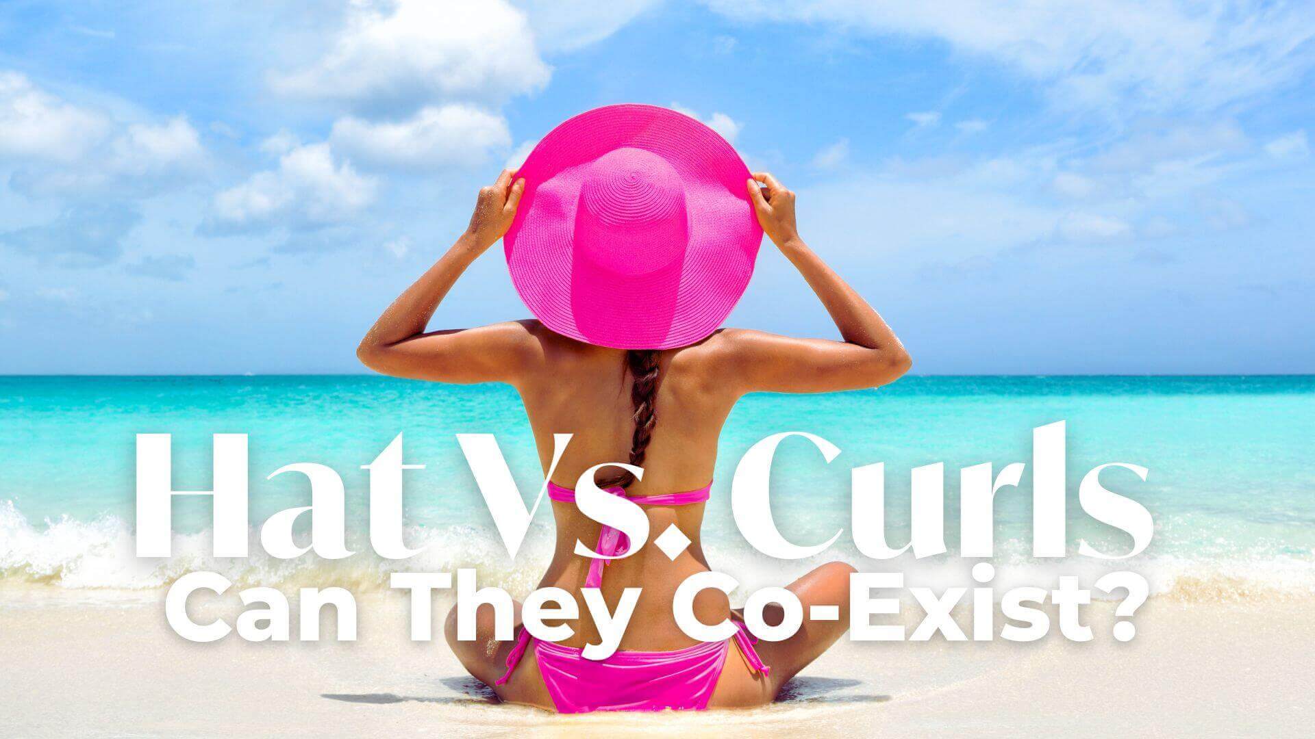 Girl sitting on the beach with bright pink hat and swimmers with the heading Hat Vs. Curls and the subheading Can They Co-Exist?