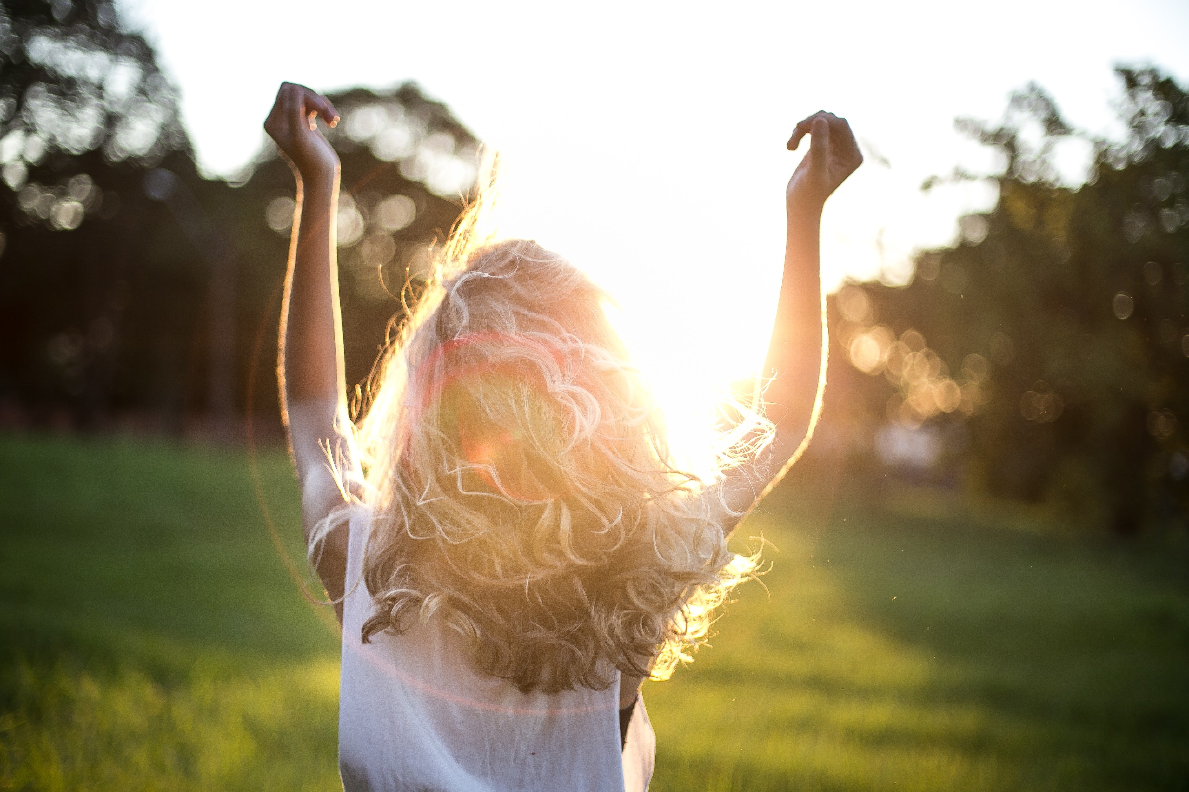 Sunlight shining through curly girls hair