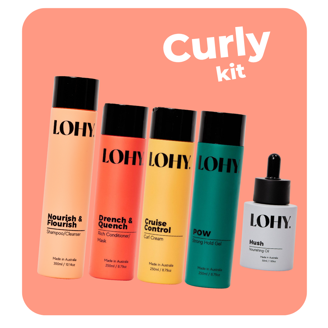 lohy. curly coarse hair kit, which includes shampoo, rich conditioner, curl cream, strong hold gel and nourishing oil bottles angled on a pastel red background