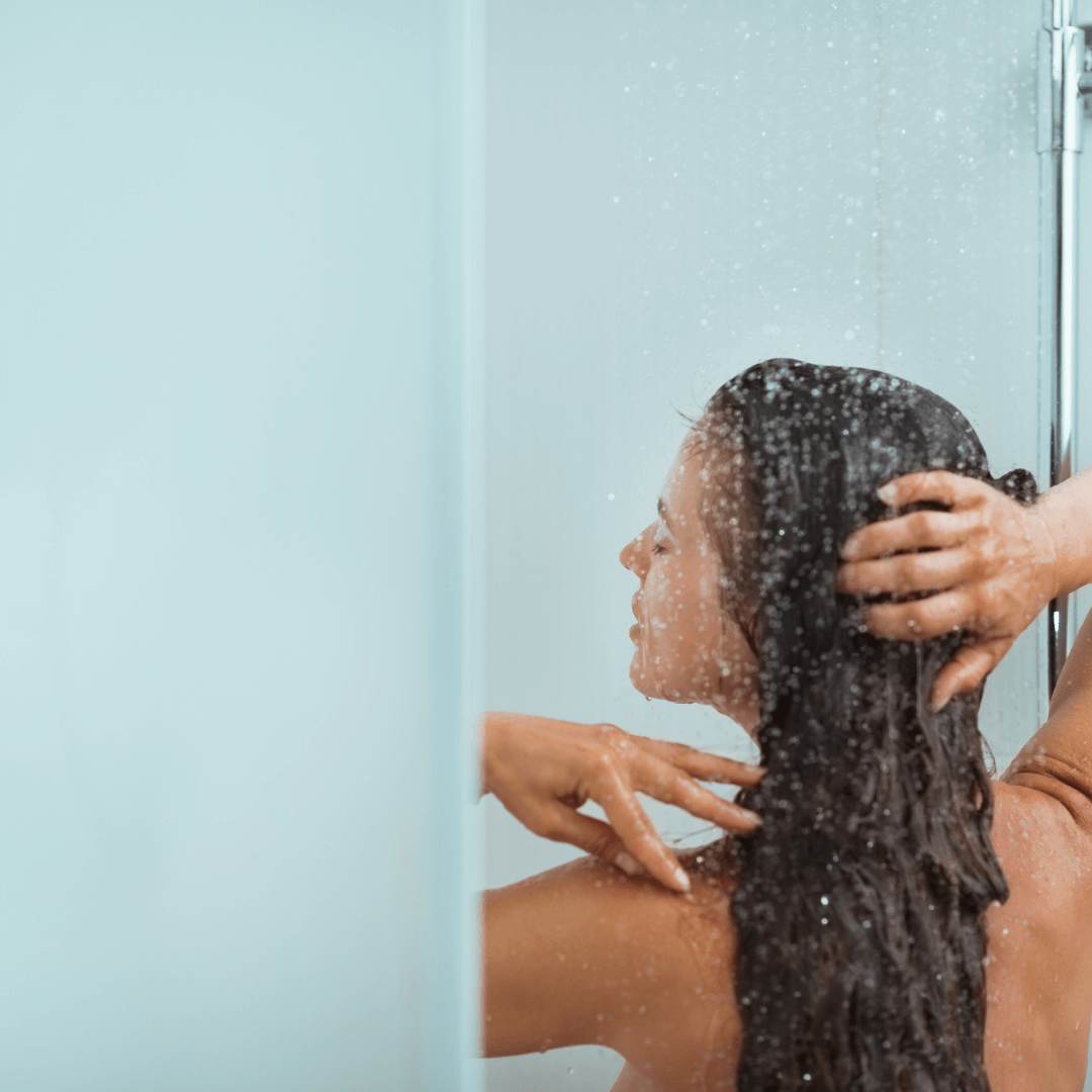 woman showering, long brunette curly hair