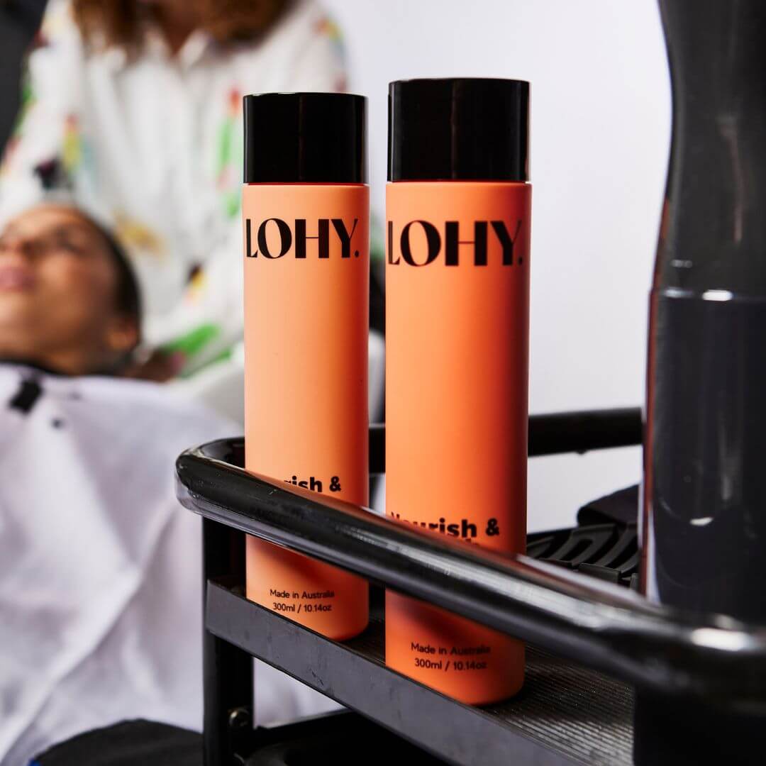 Curly hair shampoo and conditioner sitting in salon trolley