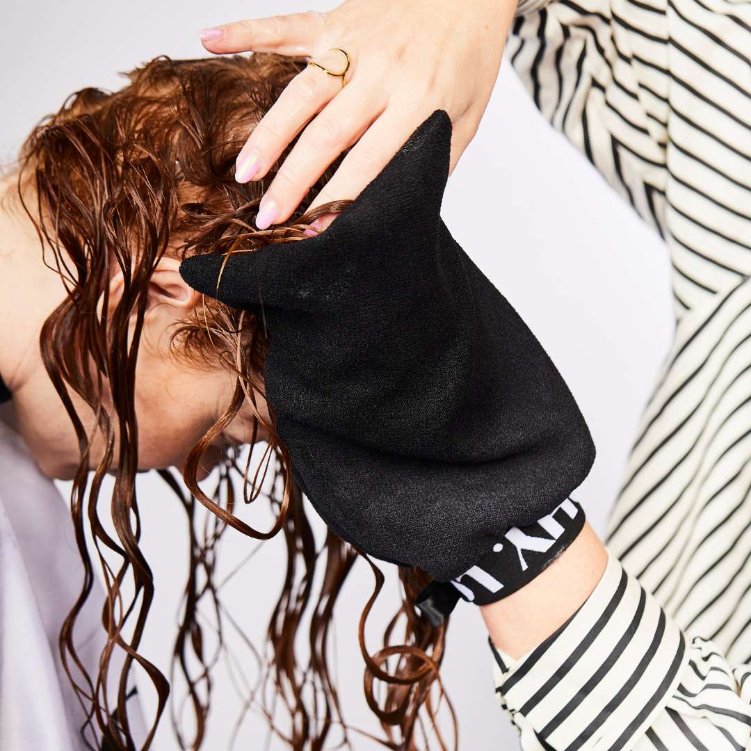 curly hair being dried with the curl hydration glove