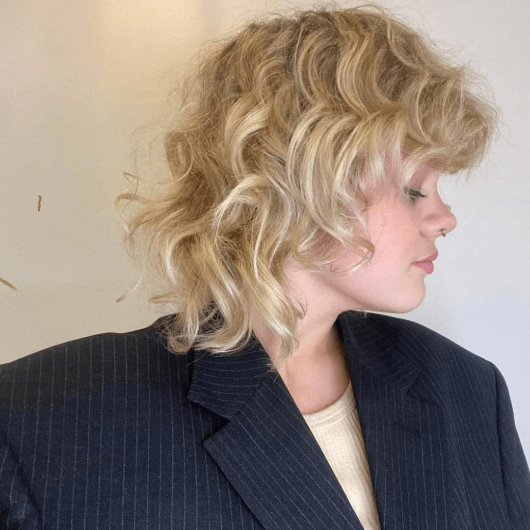 girl with short blonde curly hair