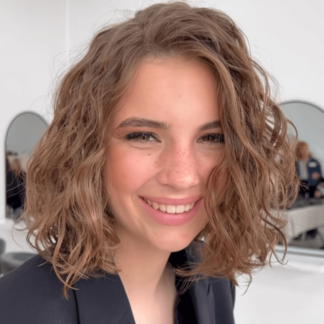 girl with short curly brunette hair