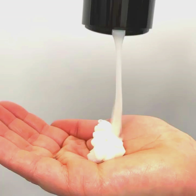 Curly hair mask being poured into hand