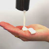 Curl cream being poured into hand