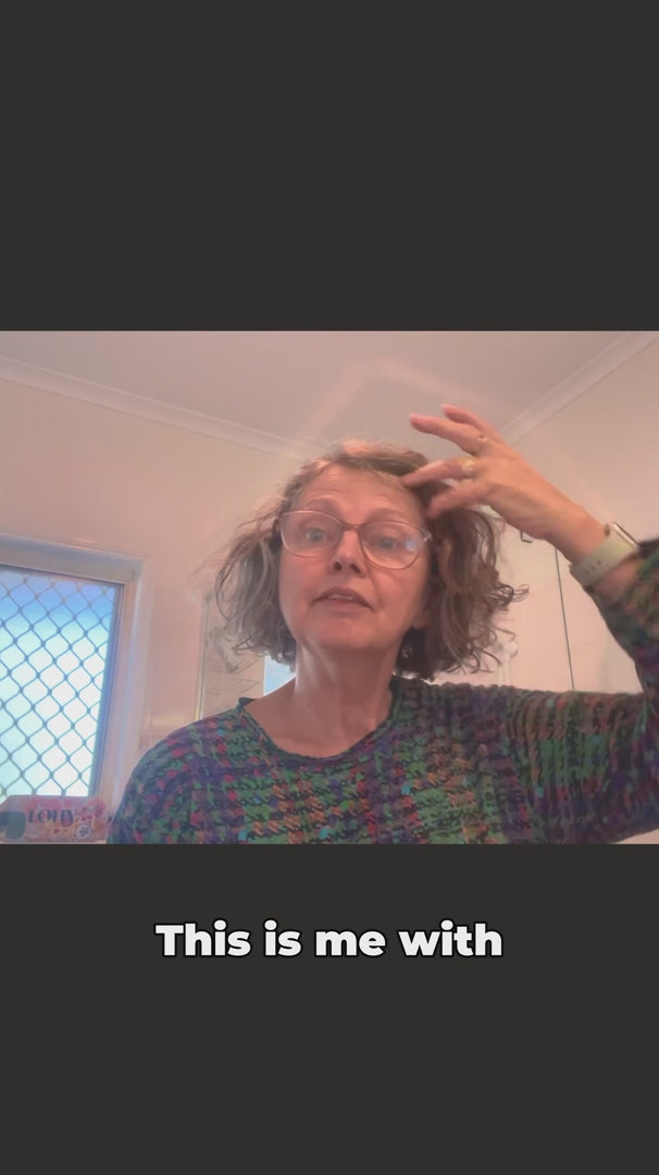 Load video: woman with brunette blonde wavy hair shows how to perform LOHY. hero routine which turns her frizzy hair to soft defined curls