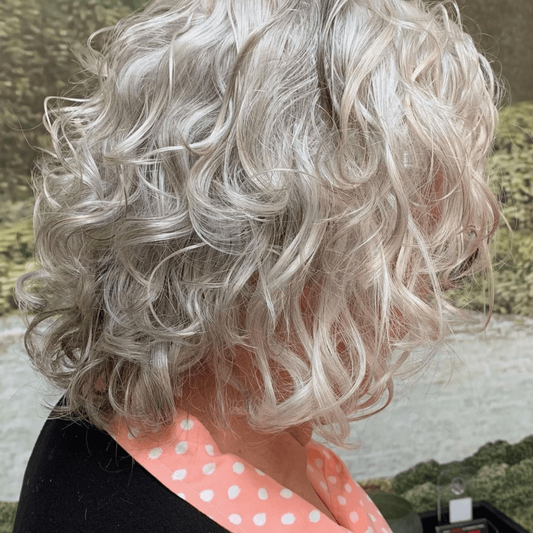 lady with short curly grey hair