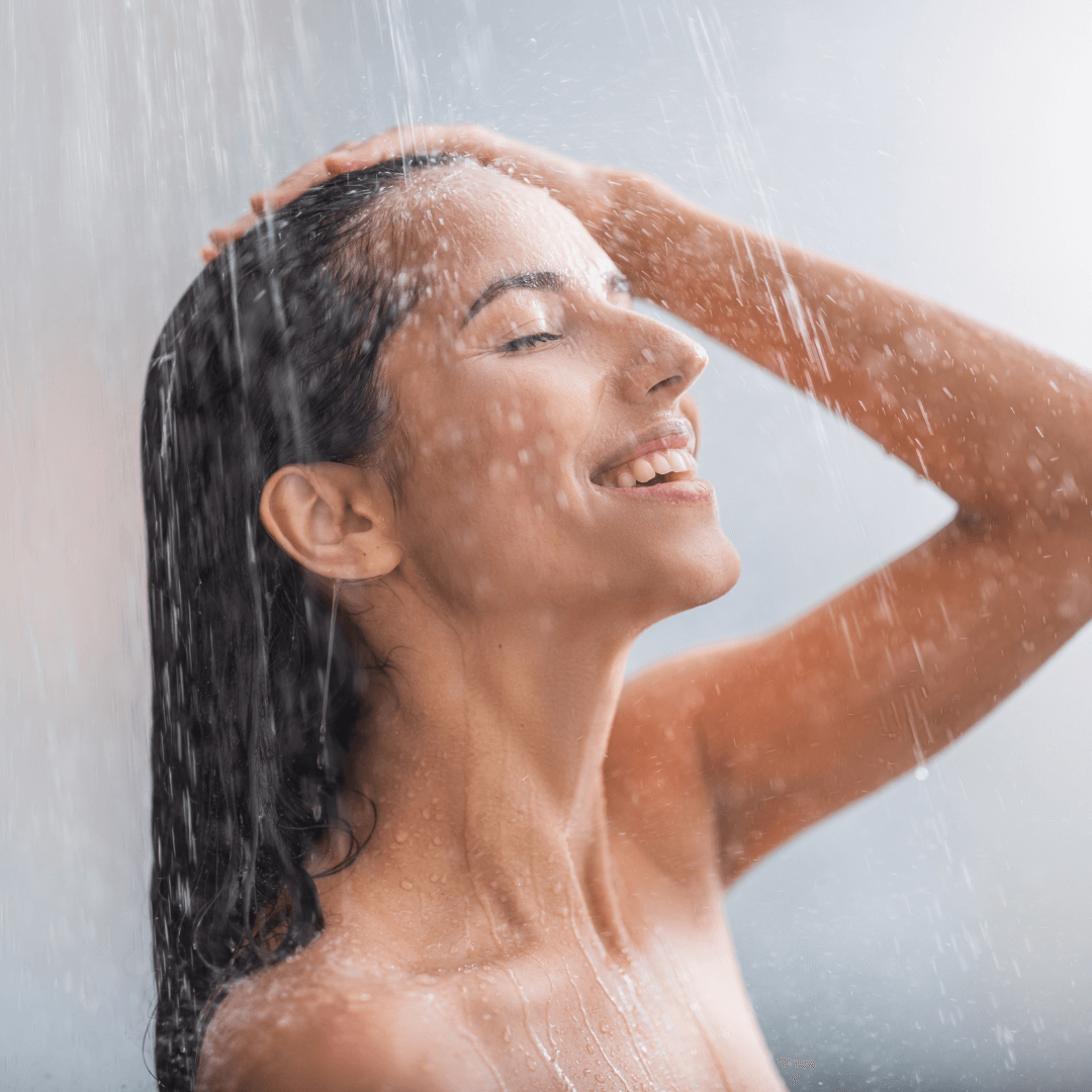 woman showering, long wet black curly hair