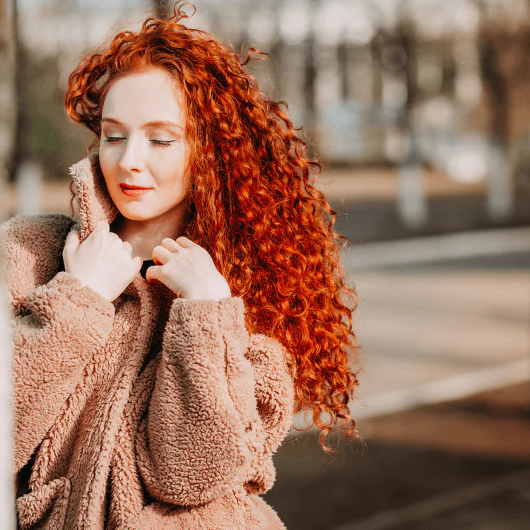 woman with long, curly, red hair